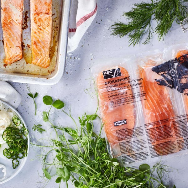 A package of IKEA salmon with herbs nearby.