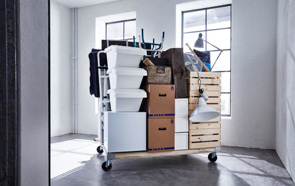 A packed apartment and moving boxes on a wagon