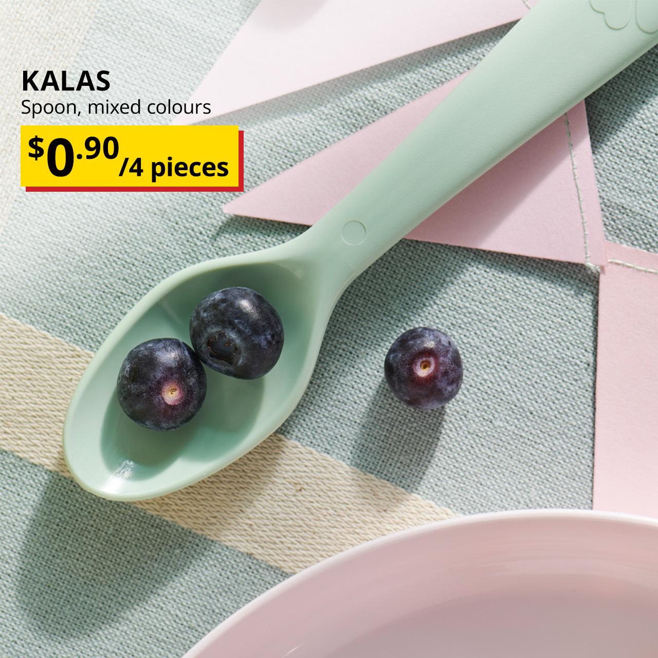 A pastel green KALAS spoon on a tablecloth with blueberries. Black text overlay image on the left that reads, "KALAS, Spoon, mixed colours" with the BTI price in yellow/red and black text: $0.90/4 pieces.