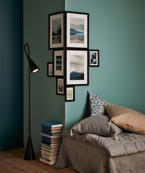 A patchwork of different-size frames with themed motifs round a corner creates a unique and strong expression.
