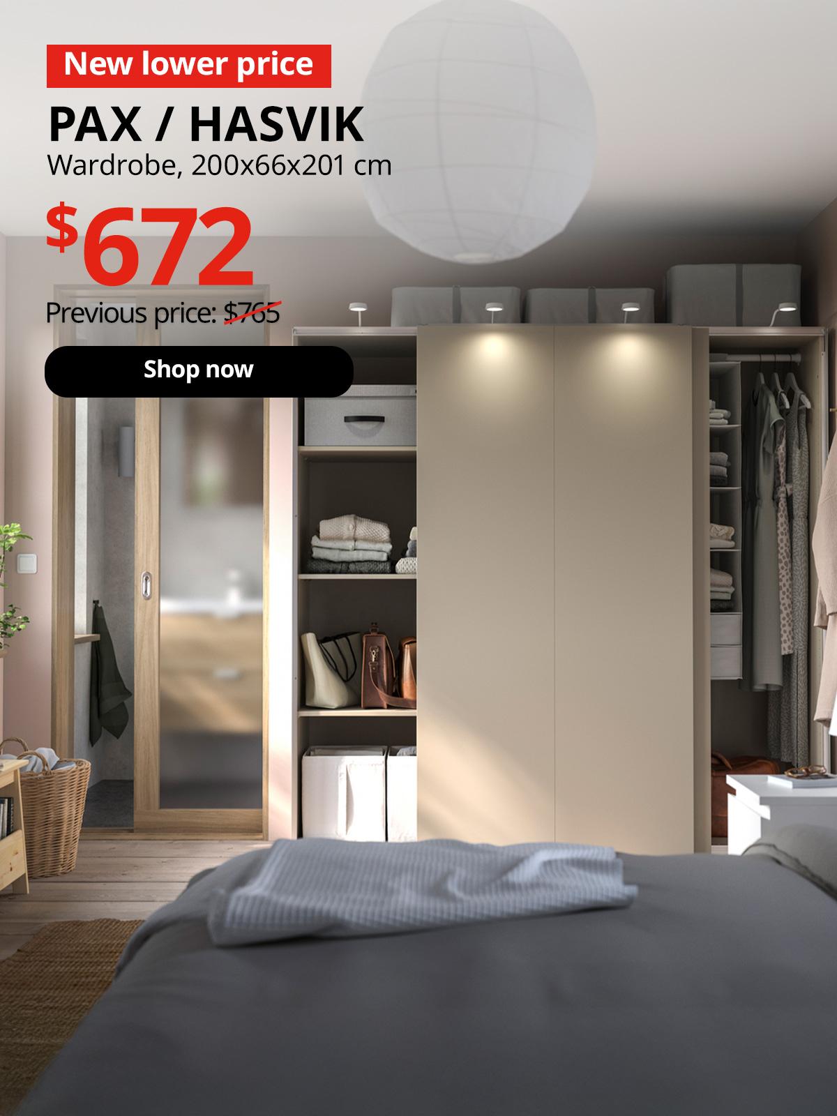 A PAX / HASVIK Wardrobe in grey-beige/grey-beige in a bedroom setting. A red tag with white text that reads "New lower price". Black text overlay image that reads "PAX / HASVIK, Wardrobe, 200x66x201 cm, Previous price: $765". New lower price in red overlay image reading "$672". 