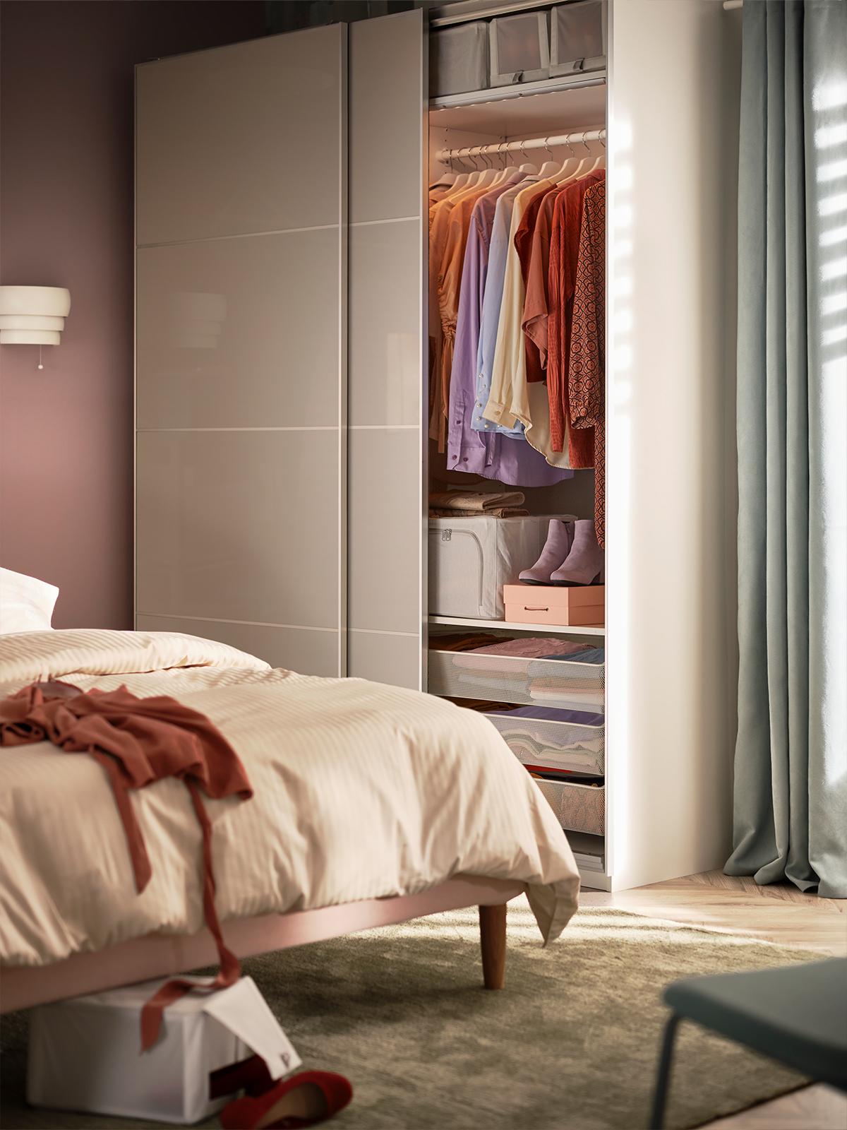 A PAX wardrobe in the bedroom with sliding doors.