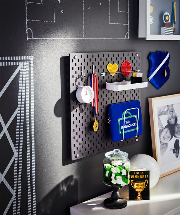 A pegboard used to keep World Cup watching essentials like first aid kit, medals, timer and playful penalty cards in place.