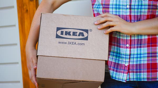 A person carrying an IKEA box.