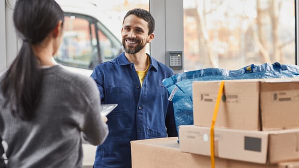 A person delivering IKEA products to another person