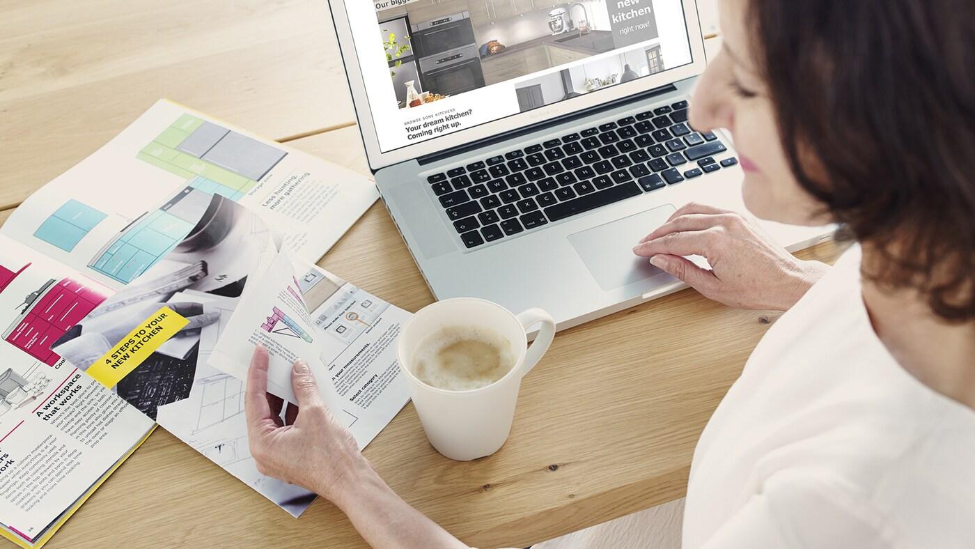 A person drinking coffee and browsing brochure