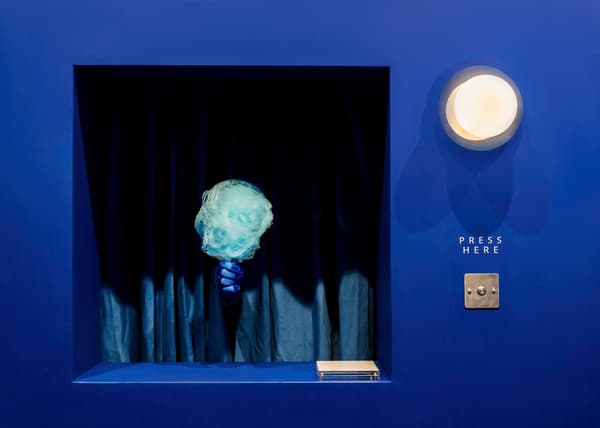 A person handing candy floss by the secret window