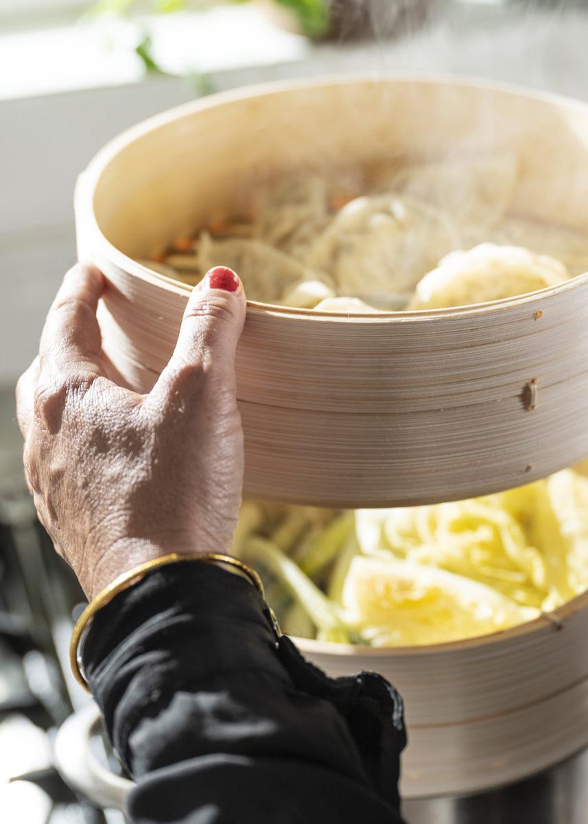 A person hanging a KLOCKREN insert full of dumplings. 