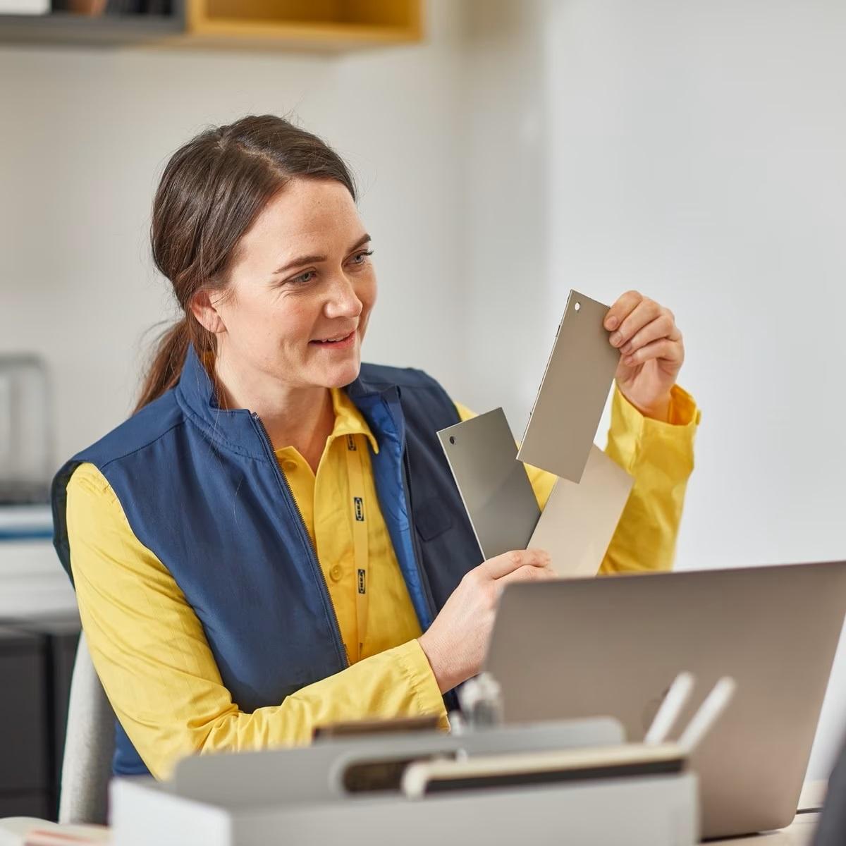A person holding 3 color swatch cards
