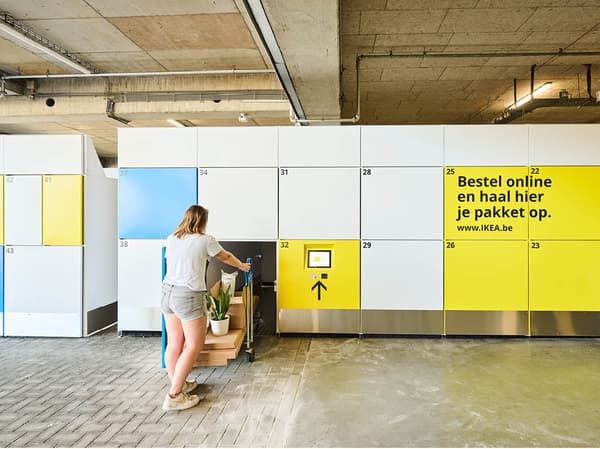 A person is using a package locker system in a modern building