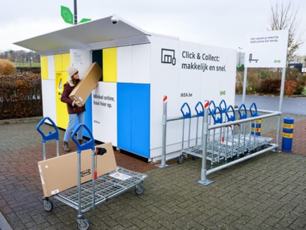 A person is using an external package locker system in a parking lot
