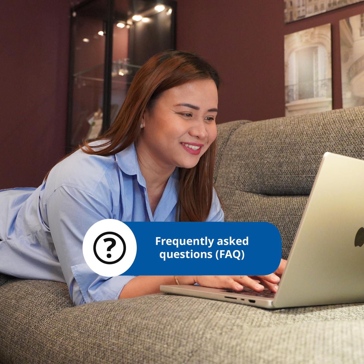 A person lounges on a couch, using a laptop with a pop-up graphic displaying "Frequently asked questions (FAQ)" in blue.