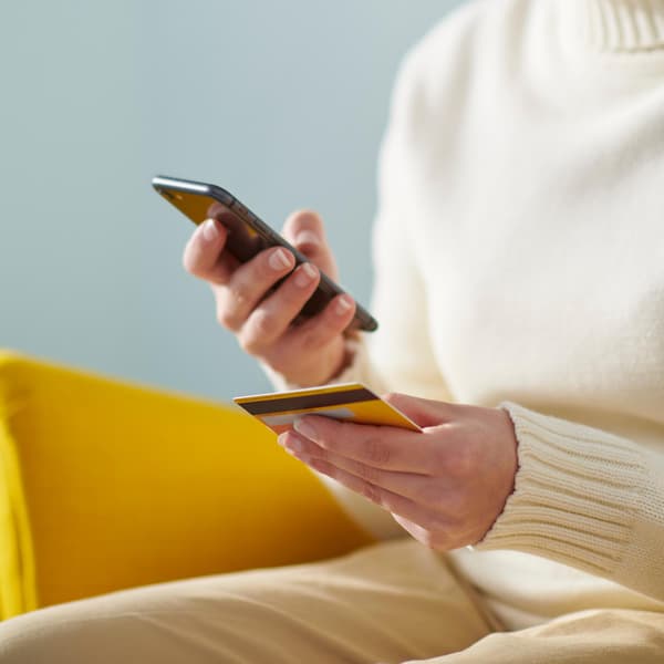 A person paying by credit card with their phone