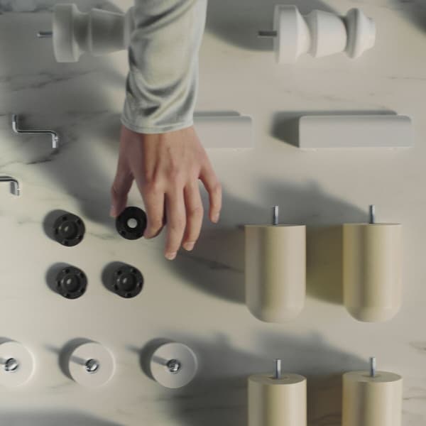A person picking up pieces of IKEA furniture