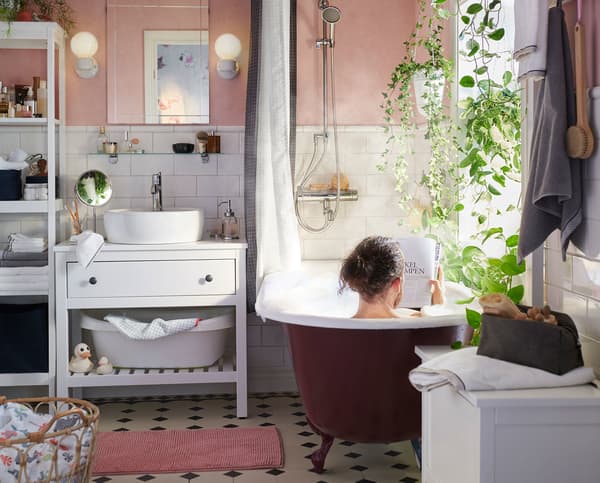 A person reading a magazine in the bath. 
