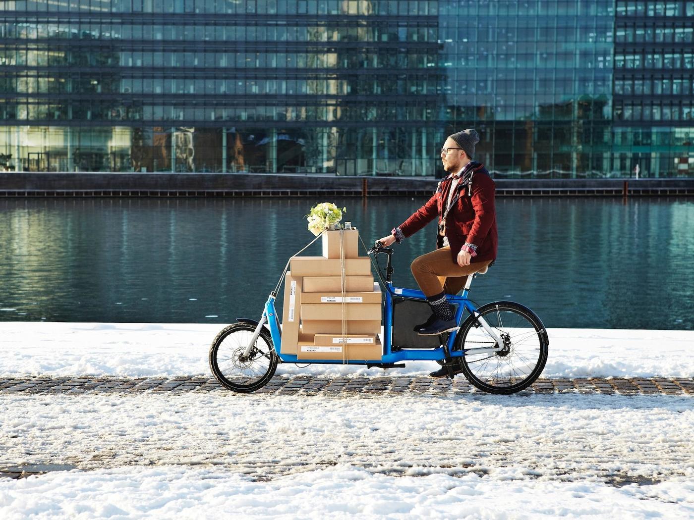 A person transporting IKEA parcels using an electric cargo bike.
