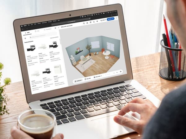 A person using a computer and planning a livingroom with IKEA Kreativ