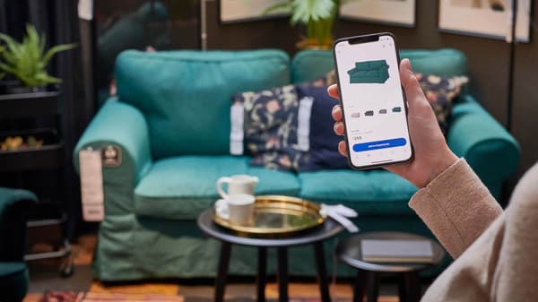 A person using the Cash App Afterpay app on their phone, while shopping at IKEA.