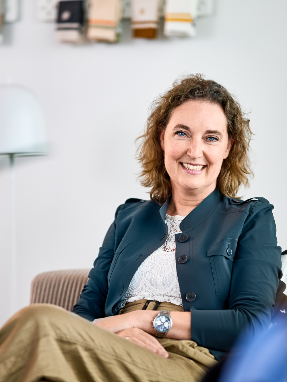 A person with a professional appearance smiling at the camera