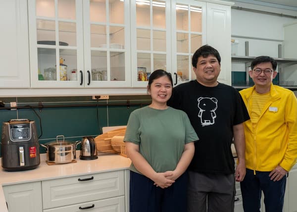 A photo of Mr Fitri & Mrs Juliana (Homeowner of a 4-room HDB) with Xavier, the kitchen planner at IKEA Jurong at their newly renovated kitchen by IKEA.