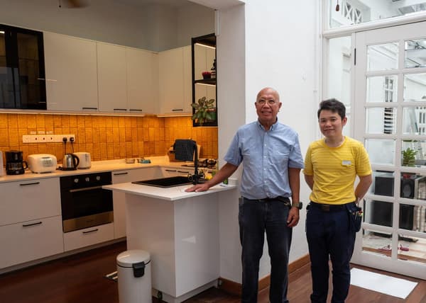 A photo of Mr John Seow (Homeowner of a landed property) and Fabian, the kitchen planner at IKEA Alexandra at his newly renovated kitchen by IKEA.
