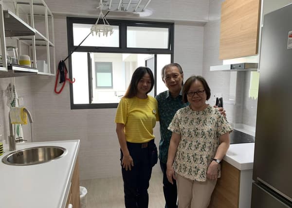 A photo of Mr Michael Lau & his wife (Homeowner of a 2-room HDB) with Hwee Ling, kitchen planner at IKEA Tampines, at their newly renovated kitchen by IKEA.