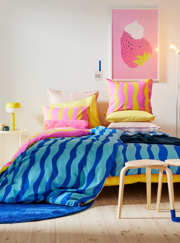 A picture of a bedroom decorated in the colors white and grey.