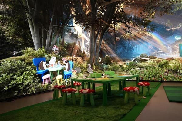 A picture of the Oxford Street IKEA store live studio showing screens depicting a forest with cartoon animals.