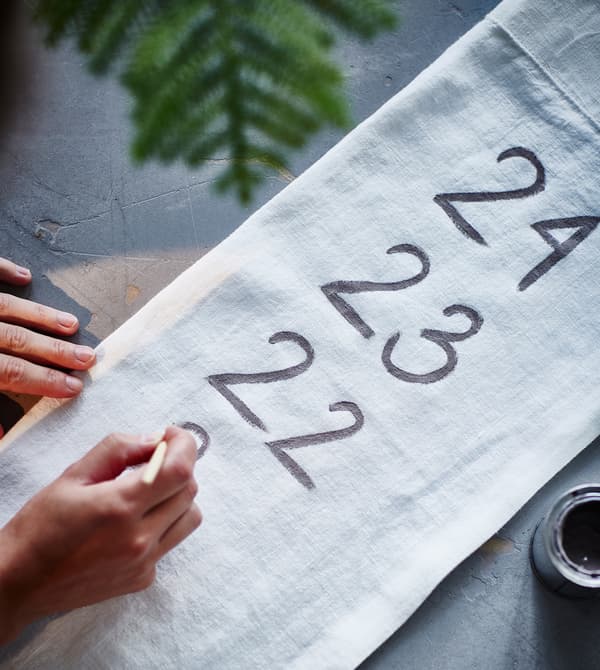 A piece of fabric is being paited with numbers.