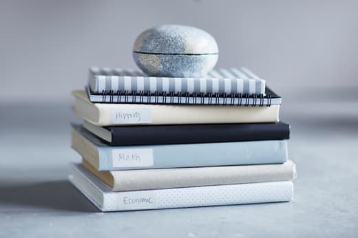 A pile of books that have been wrapped individually with wrapping paper.