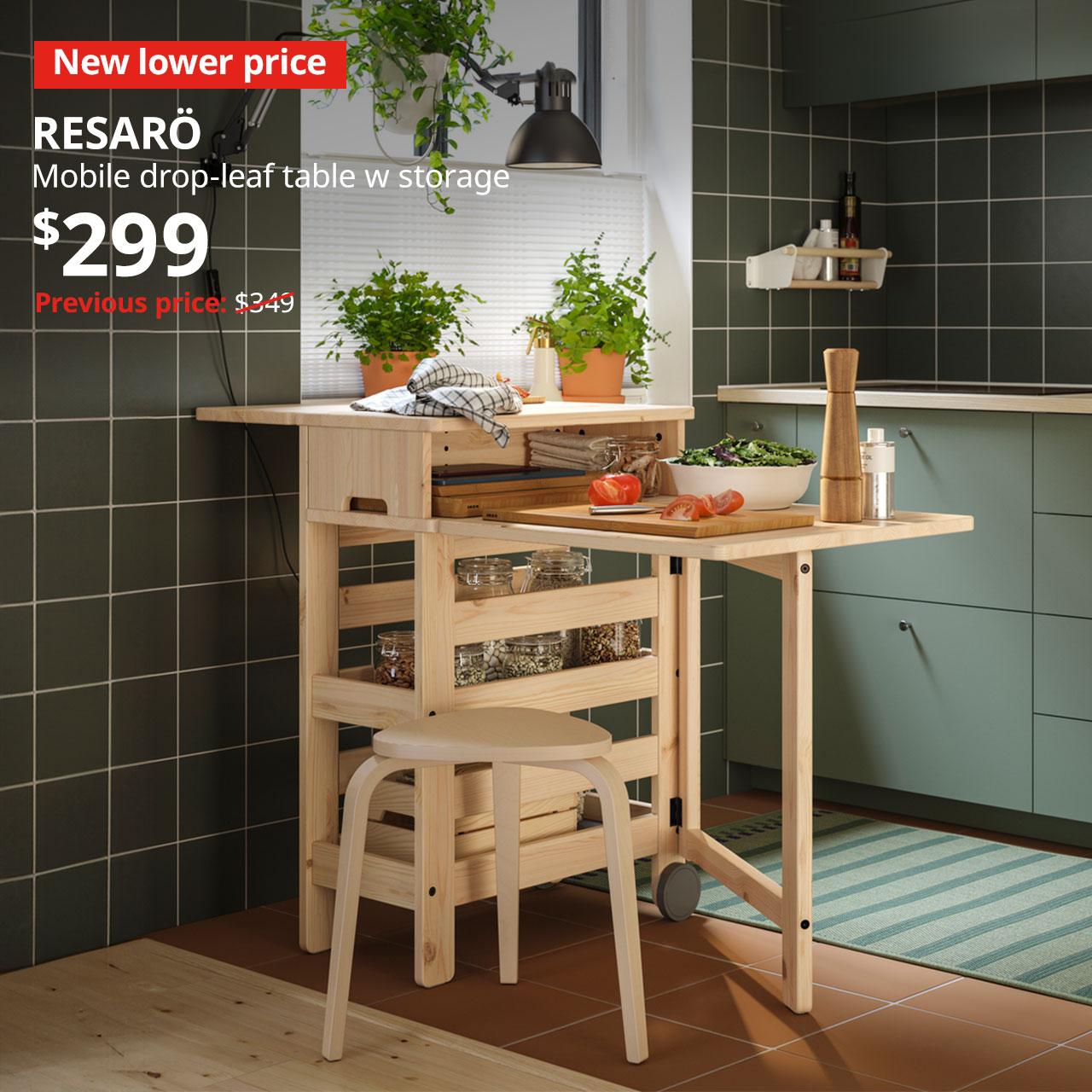 A pine finish RESARÖ mobile drop-leaf table with storage in a kitchen setting. Text on image reads "New lower price, RESARÖ, Mobile drop-leaf table w storage, $299, Previous price $349"