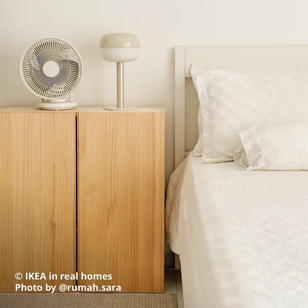 A pine IVAR cabinet being used as a bedside storage in a bedroom setting. IKEA in real homes Photo by @rumah.sara