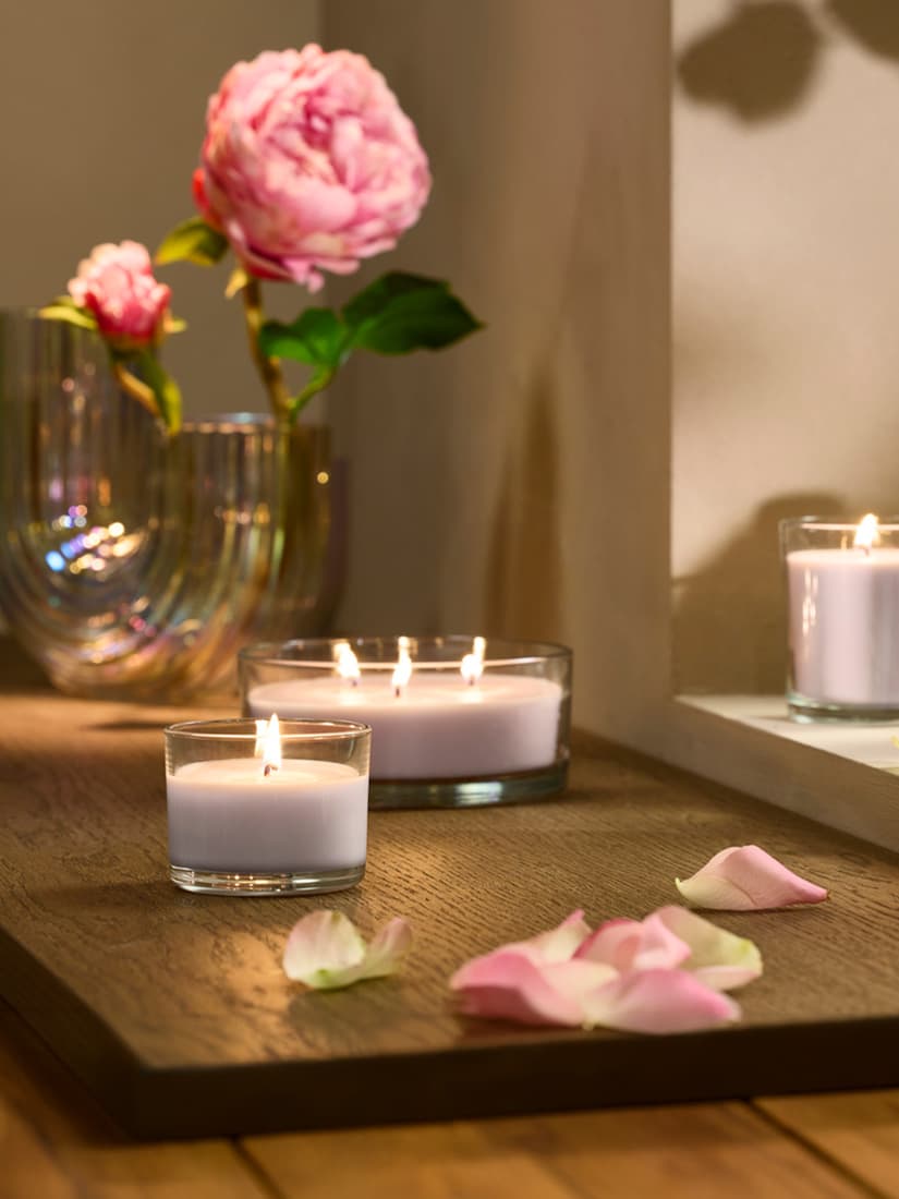 A Pink flowers pale pink LOTSFÅGEL scented candle in glass