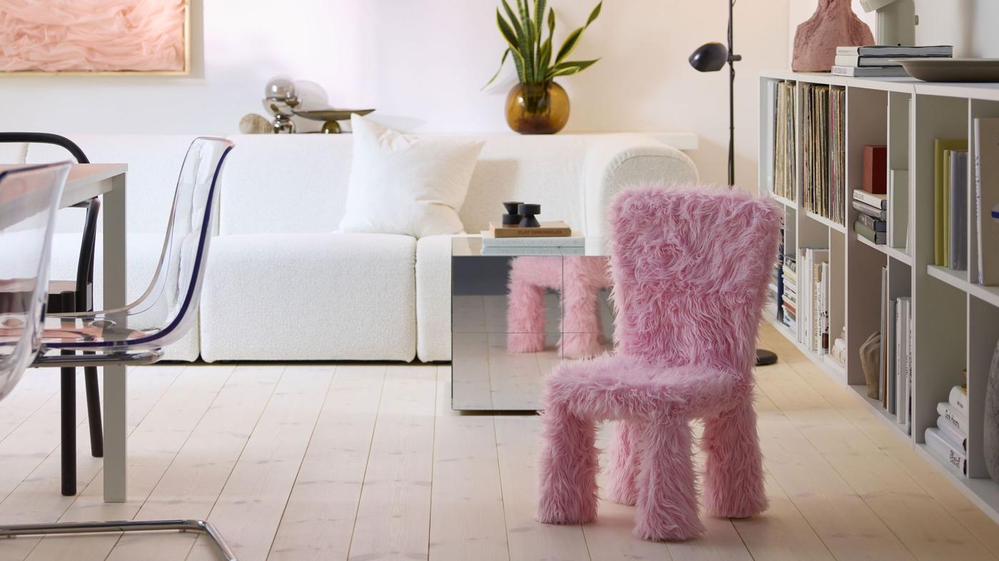 A pink fuzzy kids chair in the middle of a modern styled living room