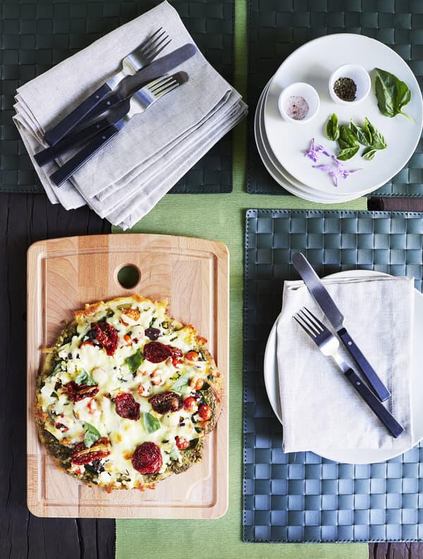 A pizza served on a wooden board.