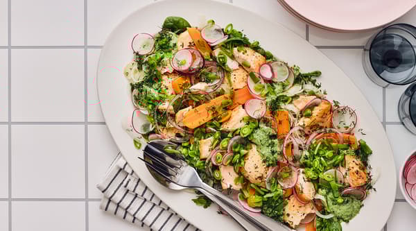 A plate featuring a salmon & veggie salad with garlic sauce
