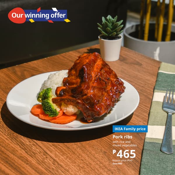  A plate of glazed pork ribs with rice, carrots, and broccoli on a wooden table. Text highlights an IKEA offer at ₱465. Cozy and appetizing setting.