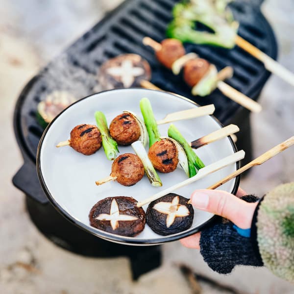 A plate of meatballs above a grill