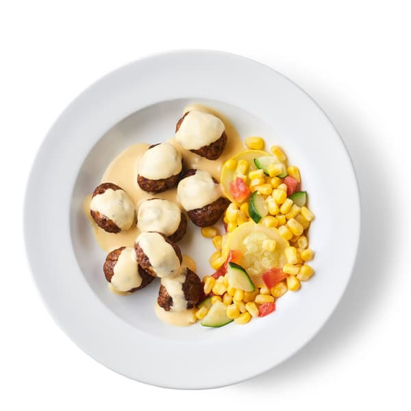 A plate of Veggie Balls Served with Lemongrass Aioli and a Corn Medley