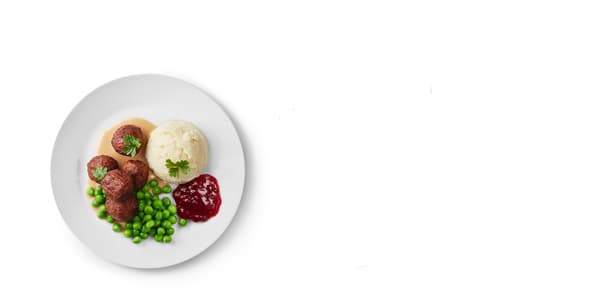 A plate with a child's portion of meatballs, mashed potatoes, peas, cream sauce and cranberries.
