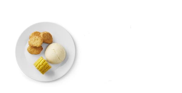 A plate with a child's portion of vegetable nuggets, a piece of boiled corn and mashed potatoes.