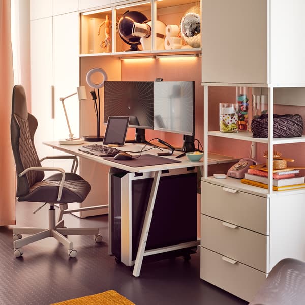 A PLATSA wardrobe with a desk and desk chair underneath
