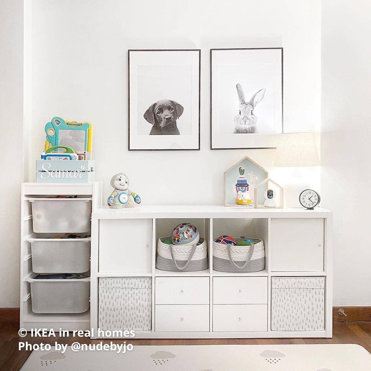 A portion of the children's room toy storage area where a white TROFAST and KALLAX shelving units are being used as storage. IKEA in real homes Photo by @nudebyjo.