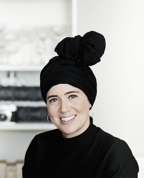A portrait of a woman with a top-knot head dress.