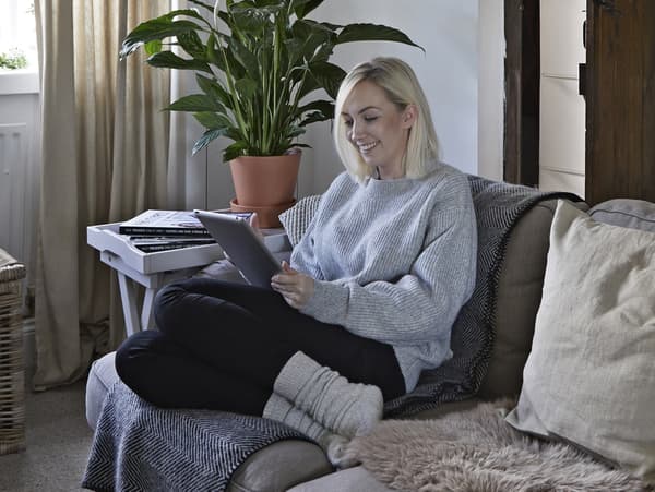 A portrait of Amanda, sitting on a sofa.