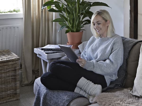A portrait of Amanda, sitting on a sofa.