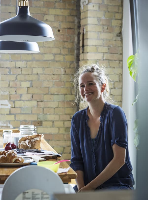 A portrait of Deborah at the dining table.