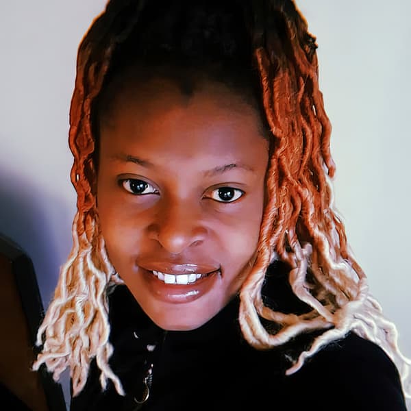 A portrait of Esperance, a Congolese refugee and IKEA Switzerland co-worker, smiling, against a white background.