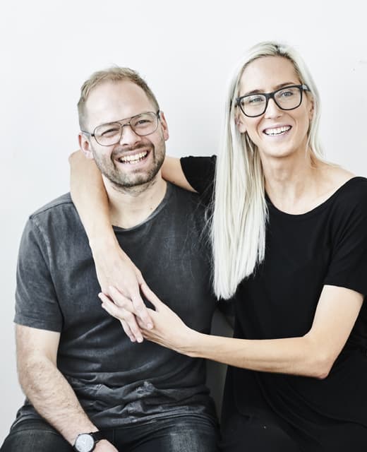 A portrait of Fiona and Bobby, the owners of a minimalist home.