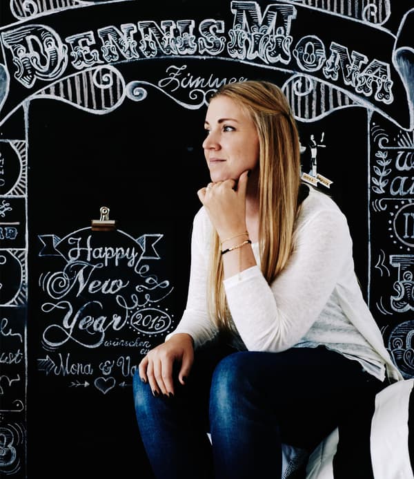 A portrait of homeowner Mona against chalkboard.